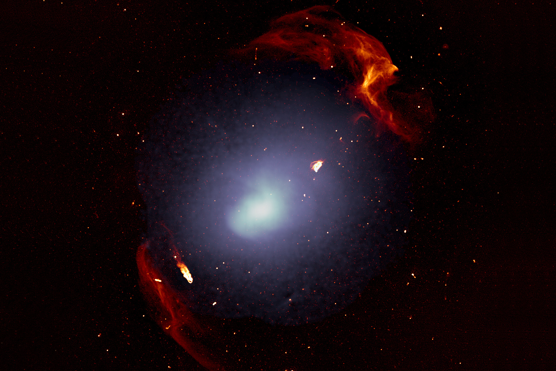 <p>Masivní kupa galaxií Abell 3667. Bílá barva ukazuje rozložení plynu, který proniká prostorem uvnitř galaxií této kupy, červené struktury představují dvě velké rázové vlny, které vznikly během formování kupy galaxií.</p>